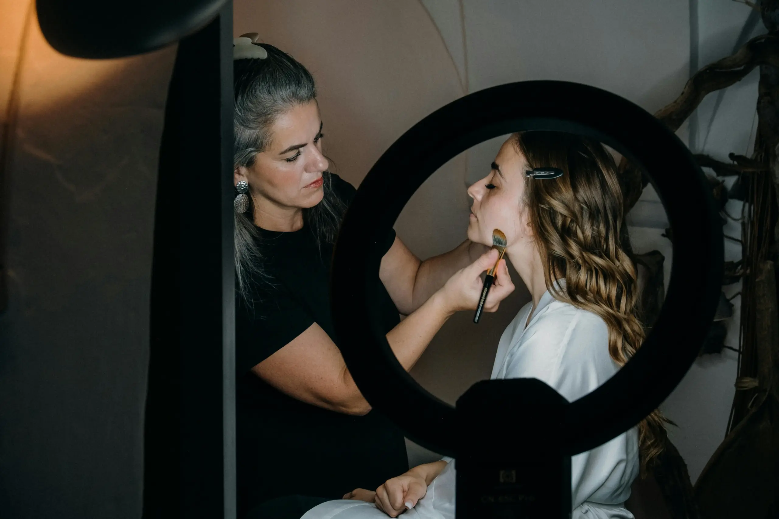 Bridal makeup artist applying natural wedding makeup to a bride before her ceremony in Ennis TX