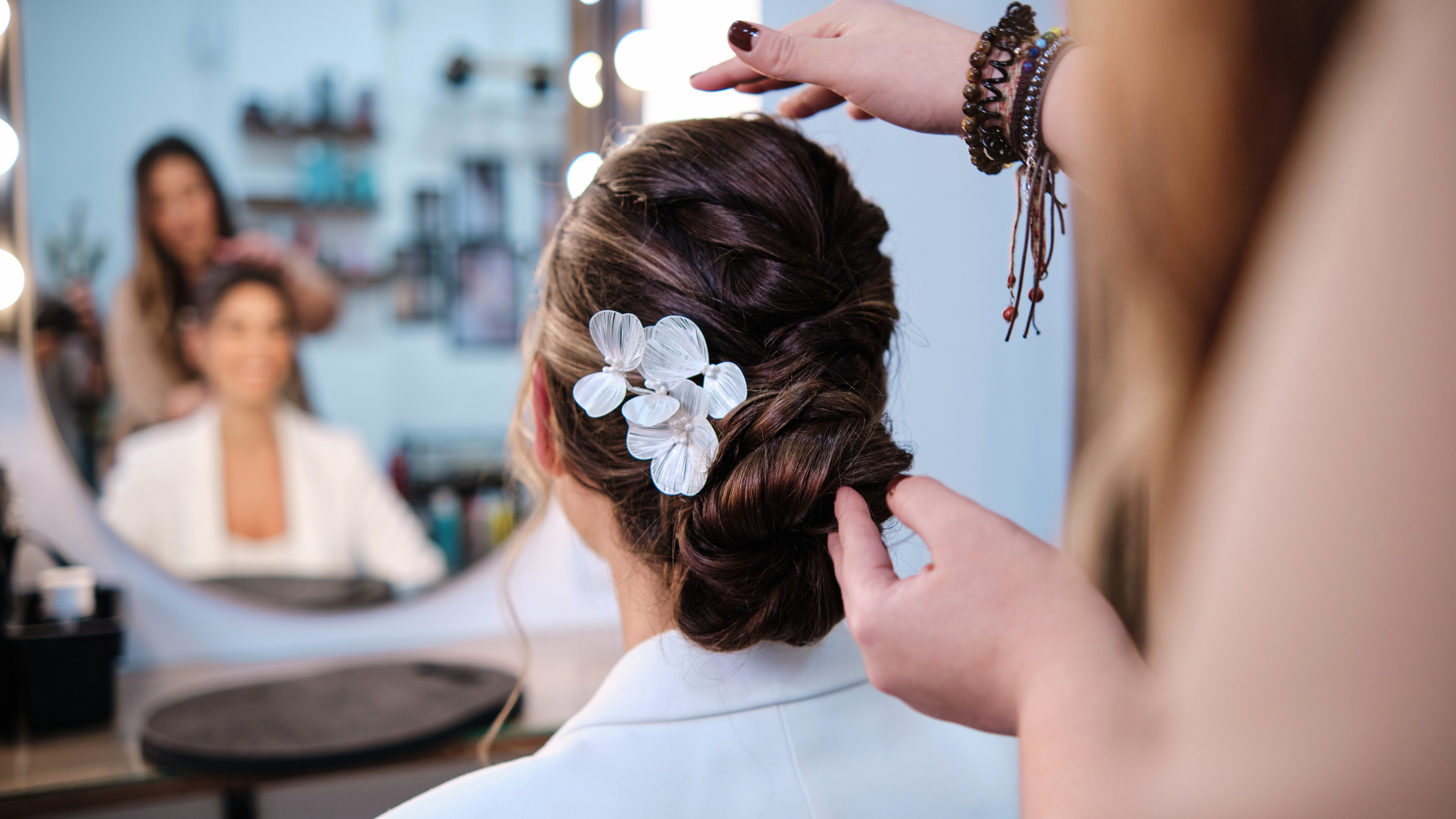 Salon de Allure stylist finishing a client's hair color appointment